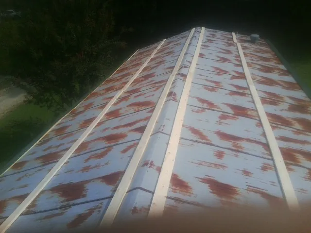 Rusted metal roof panels with new wood purlins before replacement — Storm Damage Roof Repair in Fishtail by Roofing Brothers